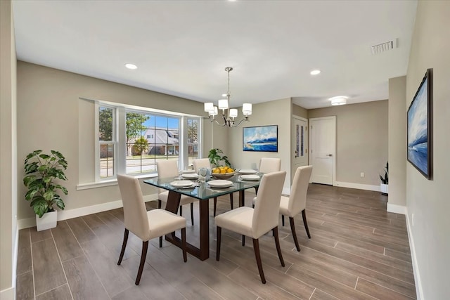 dining room featuring dark wood-type flooring and a chandelier