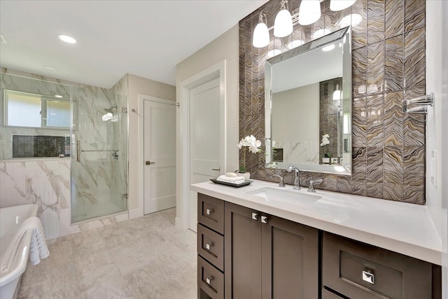 bathroom featuring vanity, tile walls, and separate shower and tub