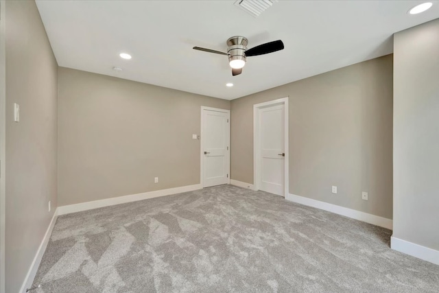 empty room with light colored carpet and ceiling fan