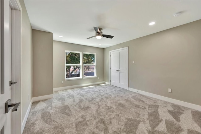 unfurnished bedroom featuring light carpet and ceiling fan