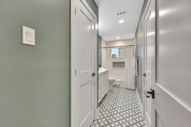 bathroom featuring vanity, a shower with shower curtain, and toilet