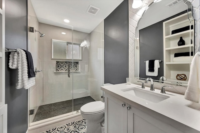 bathroom featuring vanity, toilet, and an enclosed shower