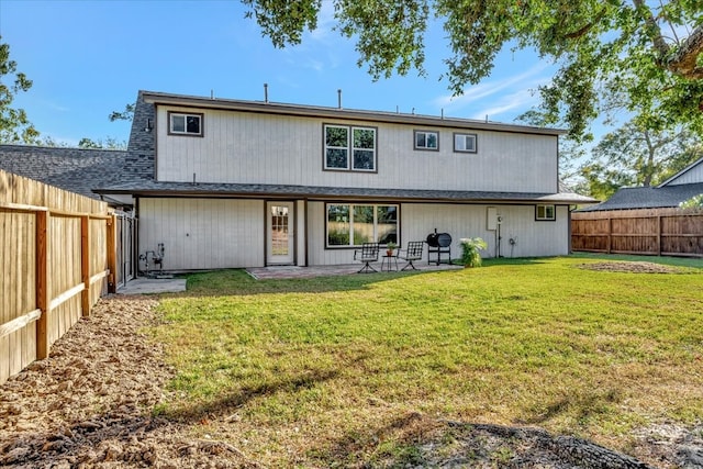 back of property featuring a patio area and a yard