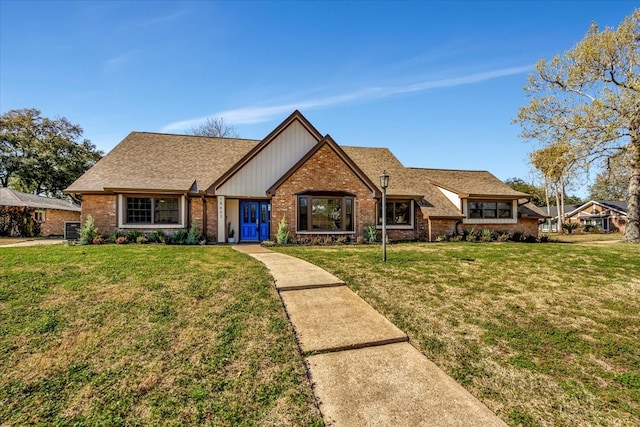 view of front of property featuring a front yard and central AC