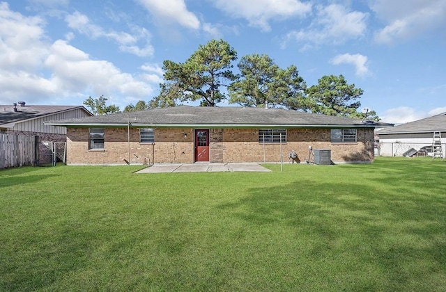 rear view of house featuring a fenced backyard, a yard, and central air condition unit