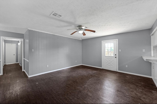 interior space featuring ceiling fan, a textured ceiling, and dark hardwood / wood-style floors