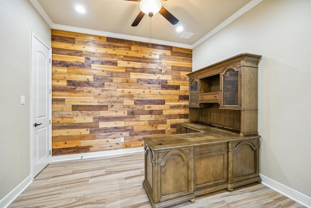 office with ceiling fan, wood walls, ornamental molding, and light hardwood / wood-style floors