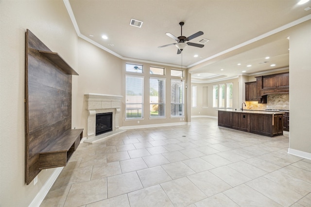 unfurnished living room with crown molding, light tile patterned flooring, plenty of natural light, and ceiling fan