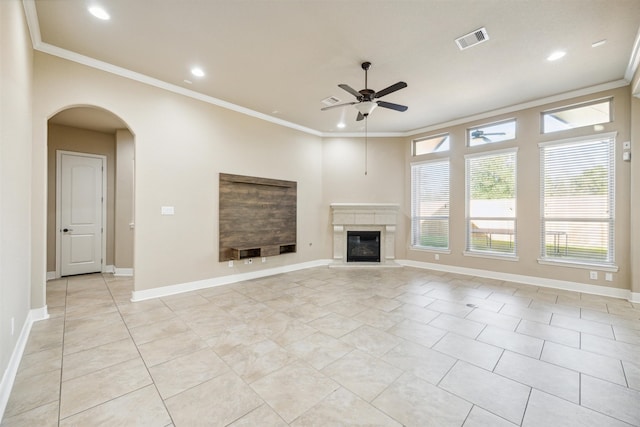 unfurnished living room with crown molding, light tile patterned floors, and ceiling fan