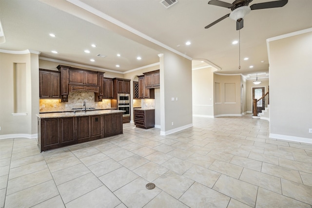 kitchen featuring tasteful backsplash, dark brown cabinetry, appliances with stainless steel finishes, and ornamental molding