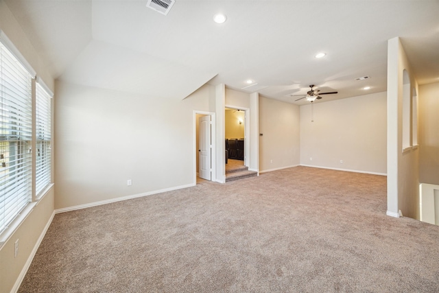 carpeted spare room with ceiling fan