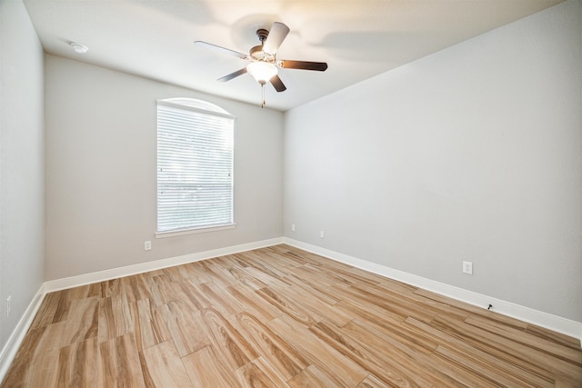 empty room with ceiling fan and light hardwood / wood-style flooring