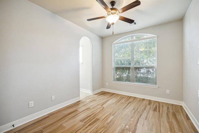 empty room with light hardwood / wood-style floors and ceiling fan