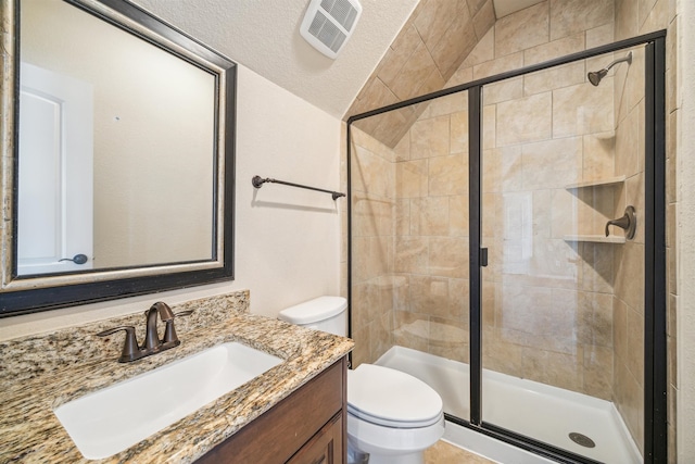 bathroom with toilet, a shower with shower door, a textured ceiling, and vanity