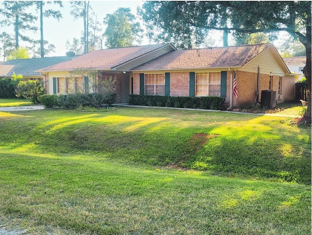 single story home featuring cooling unit and a front lawn