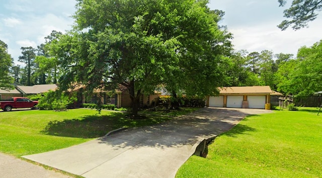 view of front of property featuring a garage and a front lawn