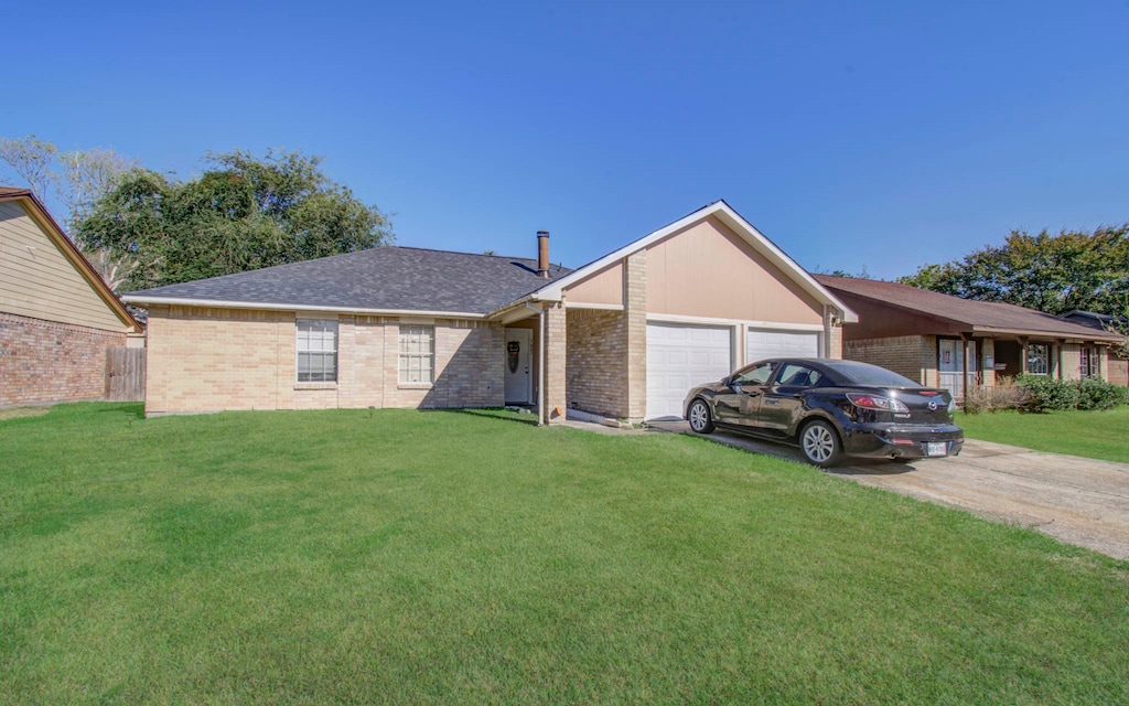 single story home with a front yard and a garage