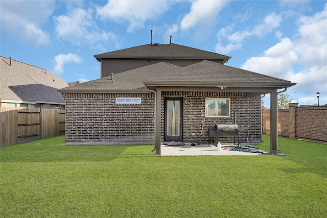 rear view of house featuring a patio area and a lawn