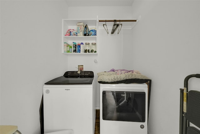 clothes washing area featuring washing machine and clothes dryer and dark hardwood / wood-style flooring