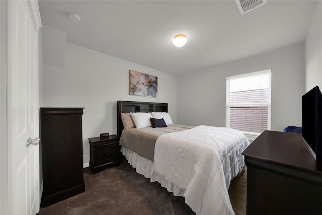 bedroom with dark colored carpet