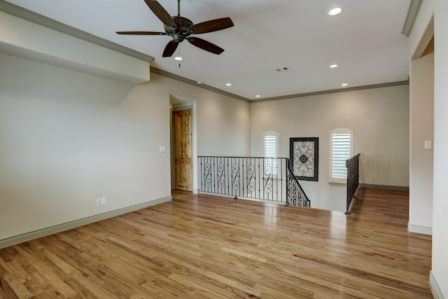 spare room with ceiling fan, ornamental molding, and light hardwood / wood-style flooring