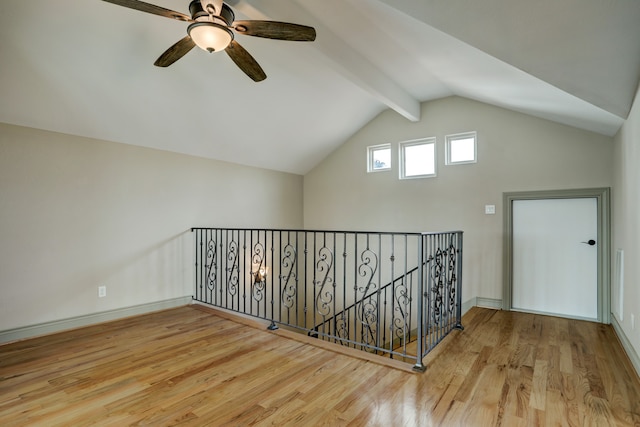 bonus room featuring lofted ceiling with beams, light wood-type flooring, and ceiling fan