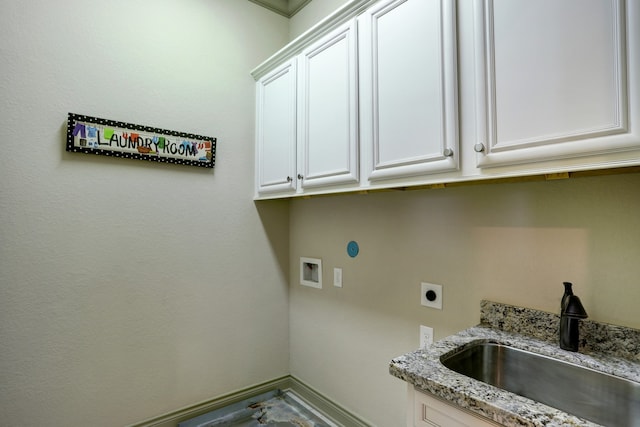 clothes washing area featuring hookup for a washing machine, electric dryer hookup, cabinets, and sink