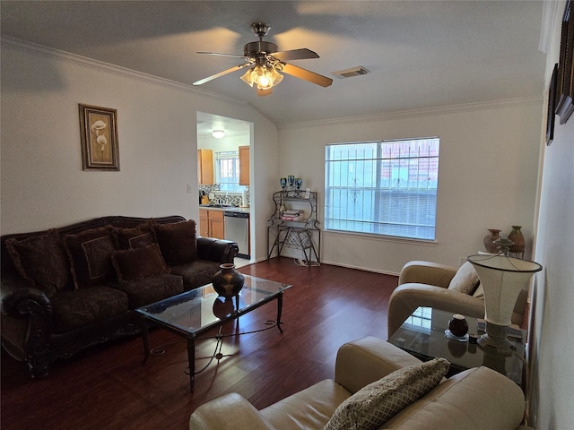 living room with lofted ceiling, ornamental molding, dark wood-type flooring, and ceiling fan