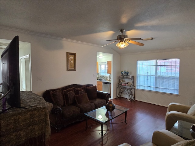 living room with crown molding, ceiling fan, a textured ceiling, and dark hardwood / wood-style flooring