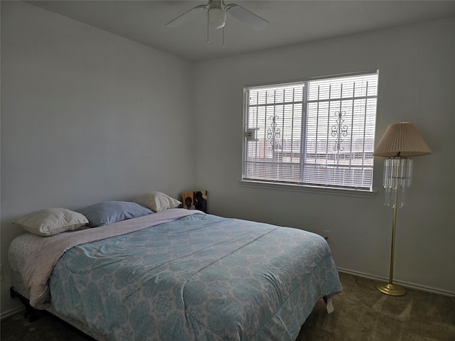 bedroom featuring dark colored carpet and ceiling fan