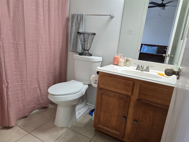 bathroom featuring toilet, curtained shower, vanity, and tile patterned floors