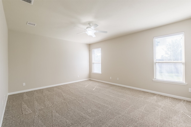 unfurnished room with a healthy amount of sunlight and light colored carpet