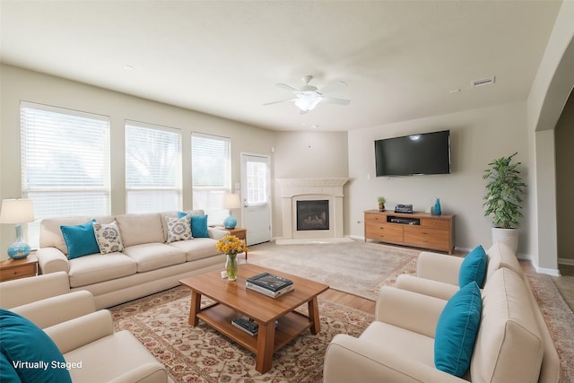 living room featuring light hardwood / wood-style floors and ceiling fan