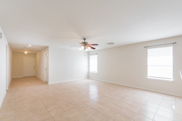 unfurnished room featuring light tile patterned floors and ceiling fan