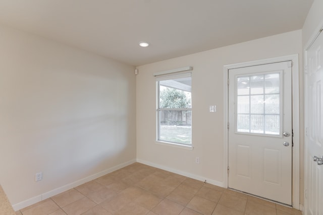 doorway with light tile patterned floors