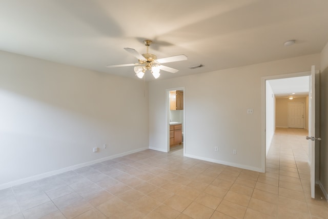 spare room with light tile patterned floors and ceiling fan