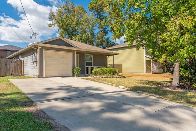 single story home featuring a front yard, covered porch, and a garage