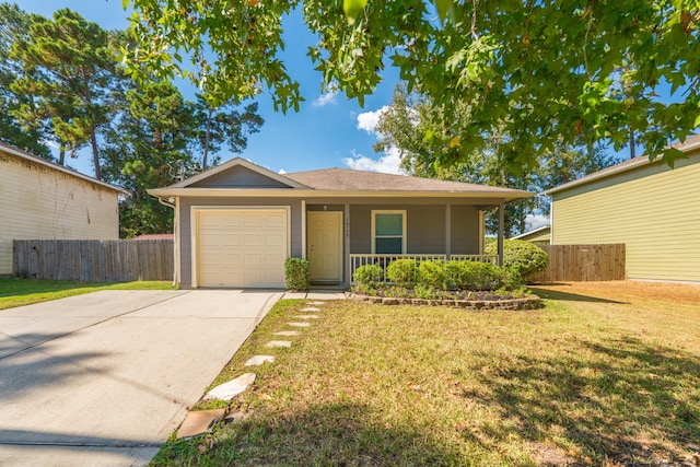 single story home featuring covered porch, a front yard, and a garage