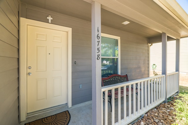 view of exterior entry with covered porch