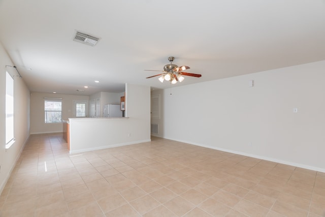 unfurnished room with ceiling fan and light tile patterned floors