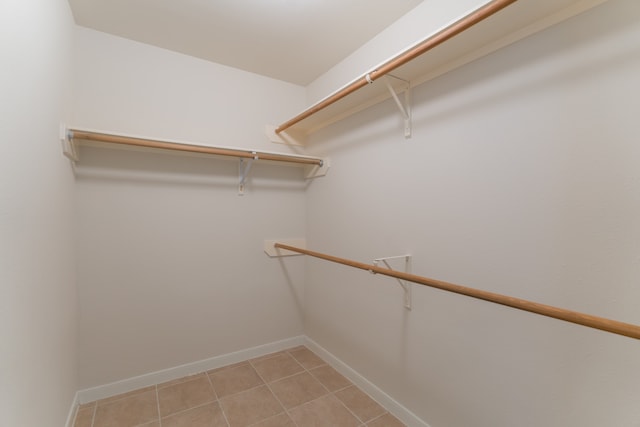 walk in closet featuring light tile patterned flooring