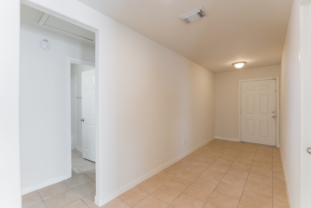 corridor featuring light tile patterned flooring