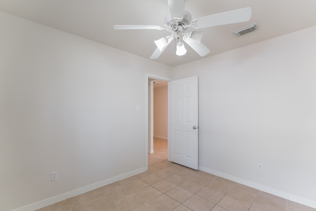 unfurnished room with ceiling fan and light tile patterned floors