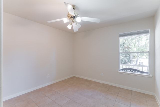 empty room featuring ceiling fan and light tile patterned floors