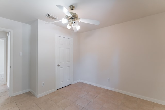 unfurnished room featuring light tile patterned floors and ceiling fan