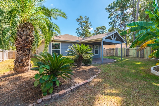 view of front of property with a front yard and a patio area