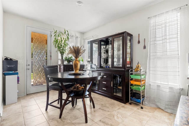 tiled dining area featuring plenty of natural light