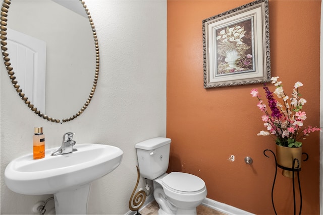 bathroom featuring sink and toilet