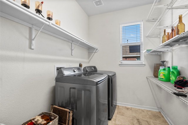 clothes washing area with washer and clothes dryer