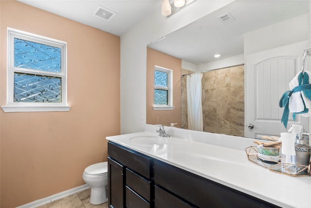 bathroom featuring walk in shower, vanity, toilet, and tile patterned flooring